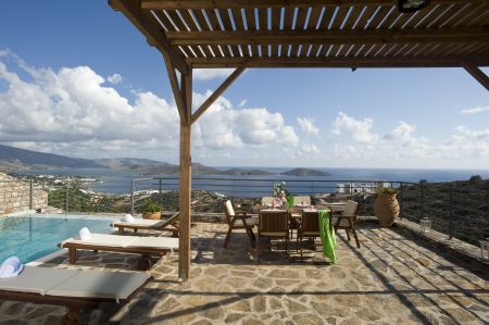  chairs under pergola and view